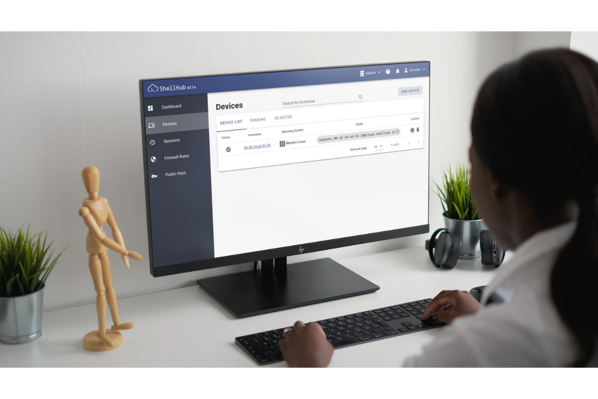 Figure 2. shows a woman using ShellHub from a desktop computer to access a device remotely through the devices section.