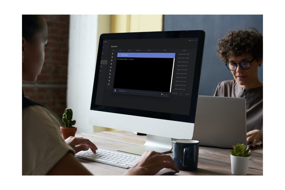 Figure 5. shows two women in an office. One of them is working on a laptop and the other is working on a desktop computer, reproducing a remote access session on ShellHub.